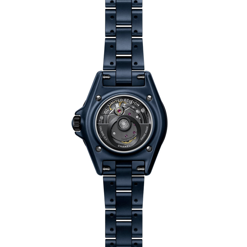 The Chanel J12 Bleu Watch Caliber 12.2, 33 mm, is a blue luxury watch featuring a visible mechanical movement and Limited Edition engraved on the case back.