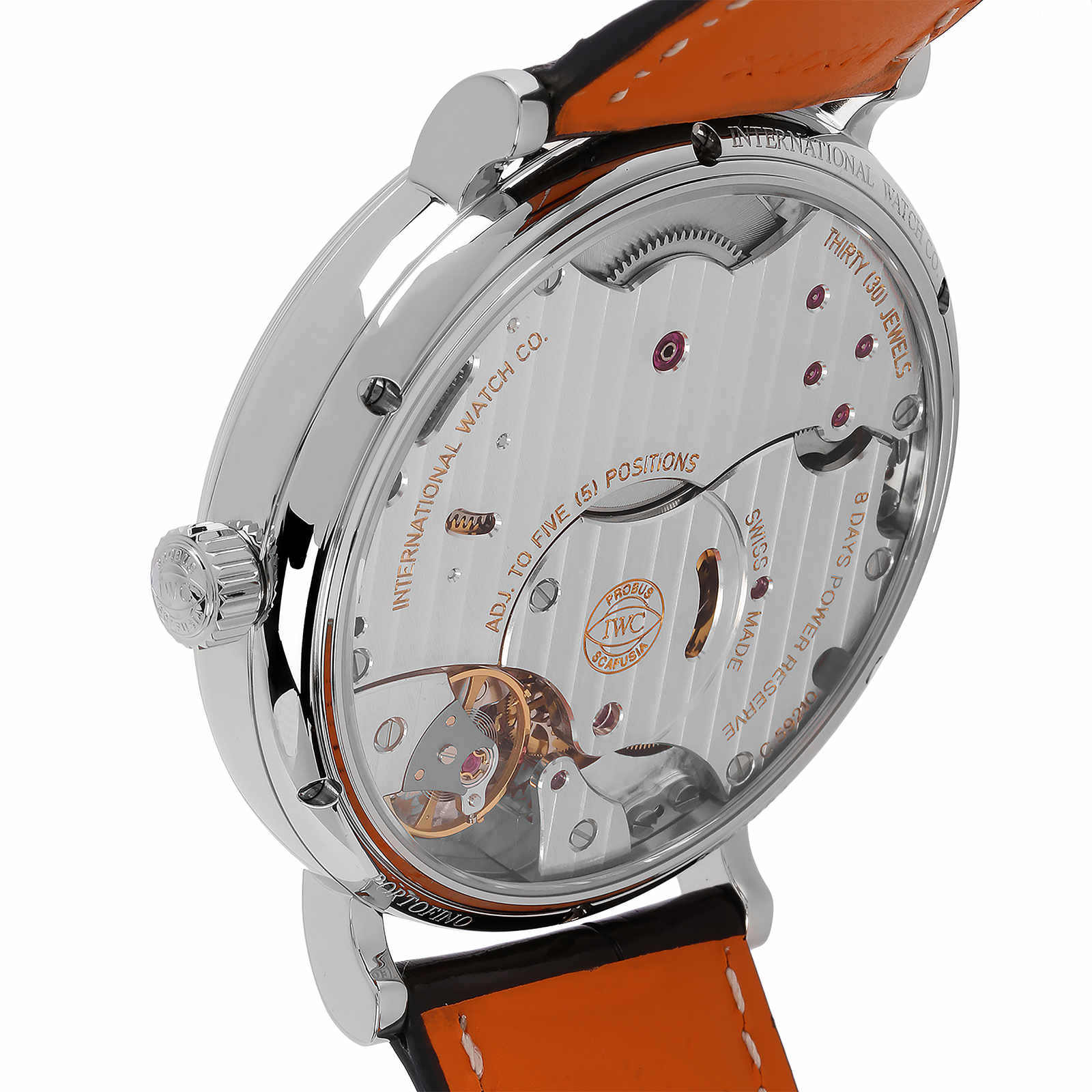 Close-up of the back of the IWC Schaffhausen Portofino Hand-Wound Eight Days, highlighting its 59210 caliber movement, engraved markings, and striking orange leather strap.