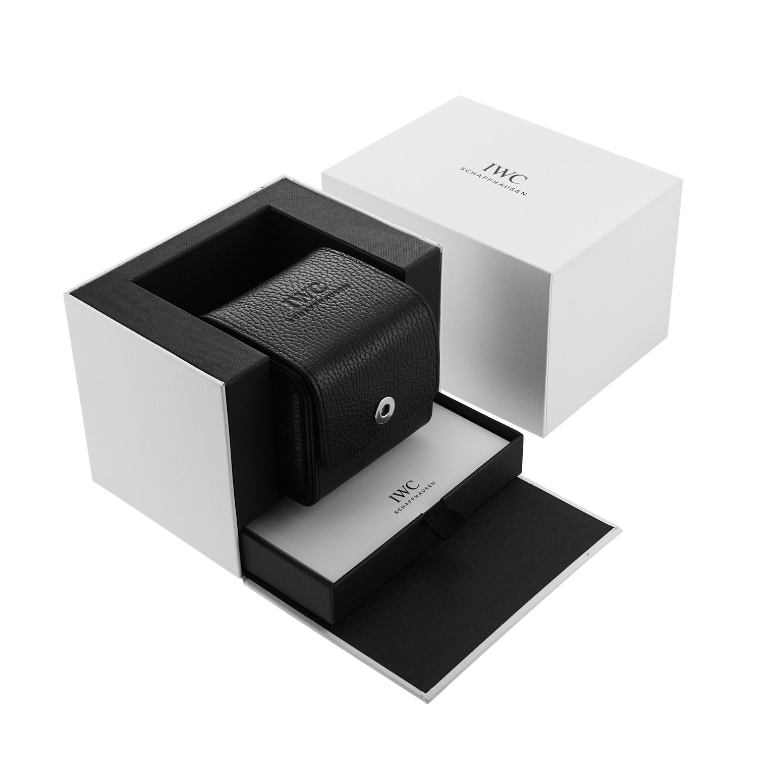 A black leather IWC Schaffhausen case rests in an open white IWC box, with booklet and outer packaging—ideal for storing your Big Pilots Watch Heritage automatic timepiece.