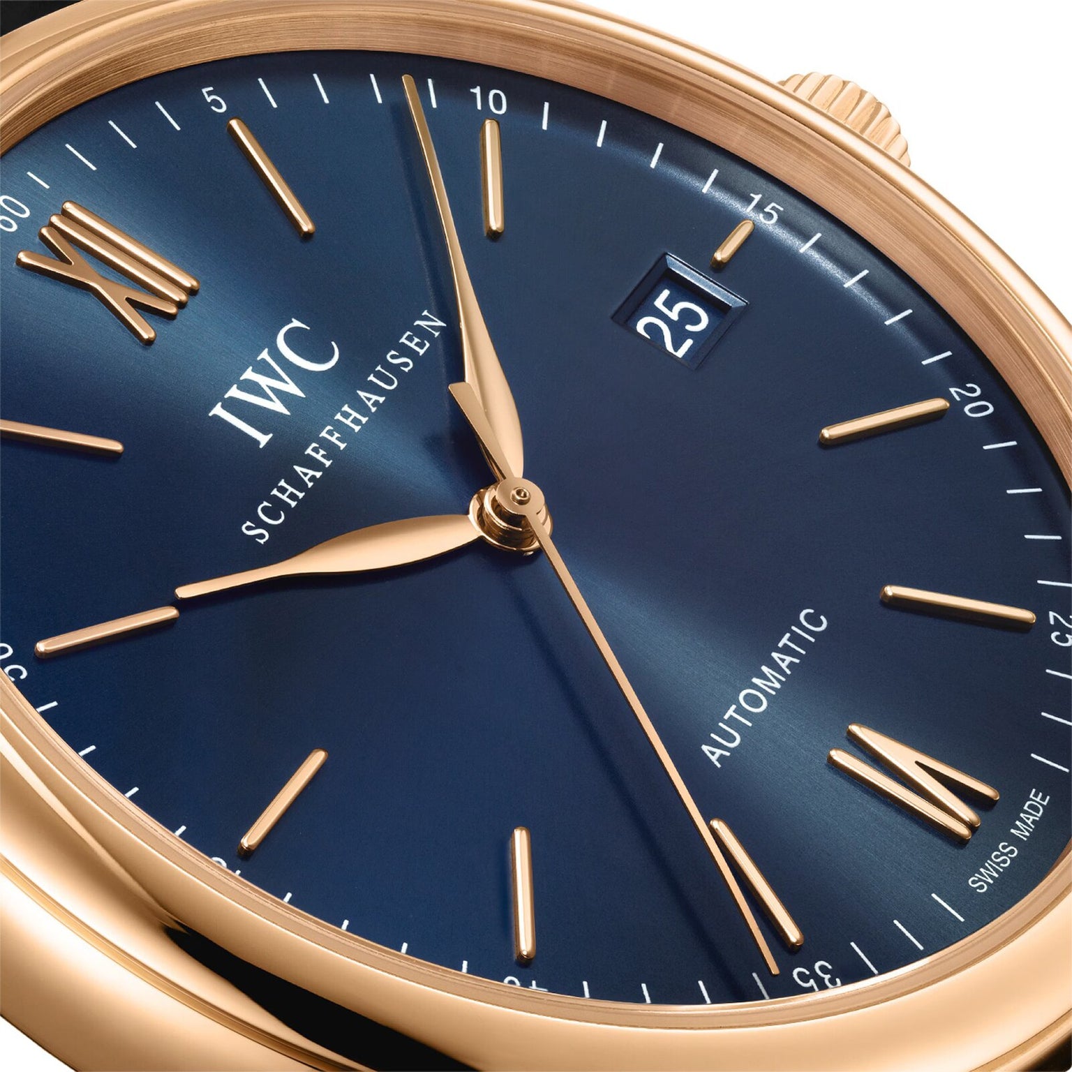 Close-up of the IWC Schaffhausen Portofino Automatic wristwatch featuring a blue dial, gold hands and markers, date display at 3 o’clock, and Automatic near 6—highlighting Swiss precision and self-winding movement.