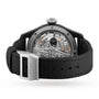 Rear view of the IWC Schaffhausen Big Pilots Watch Perpetual Calendar Edition Rodeo Drive with an exposed mechanical movement, black textured strap, silver IWC-engraved buckle, and a durable ceramic and titanium case.