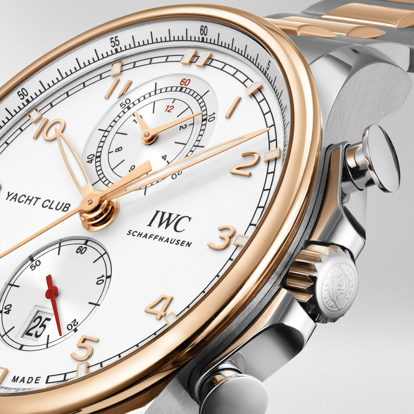 Close-up of the IWC Schaffhausen Portugieser Yacht Club Chronograph, a top nautical sports watch with white dial, gold accents, date display, and a stainless steel case.