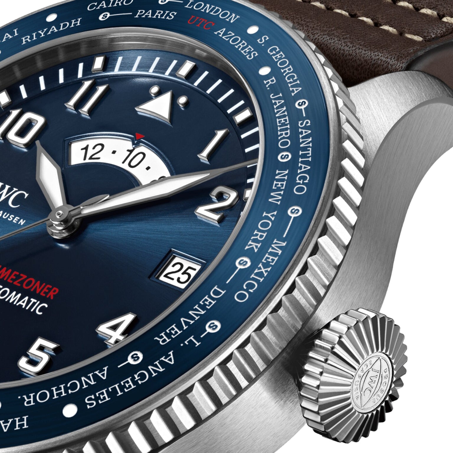 Close-up of the IWC Schaffhausen Pilots Watch Timezoner Edition Le Petit Prince with a blue dial, city names on the bezel, date window, leather strap with visible stitching, and a stainless steel case.