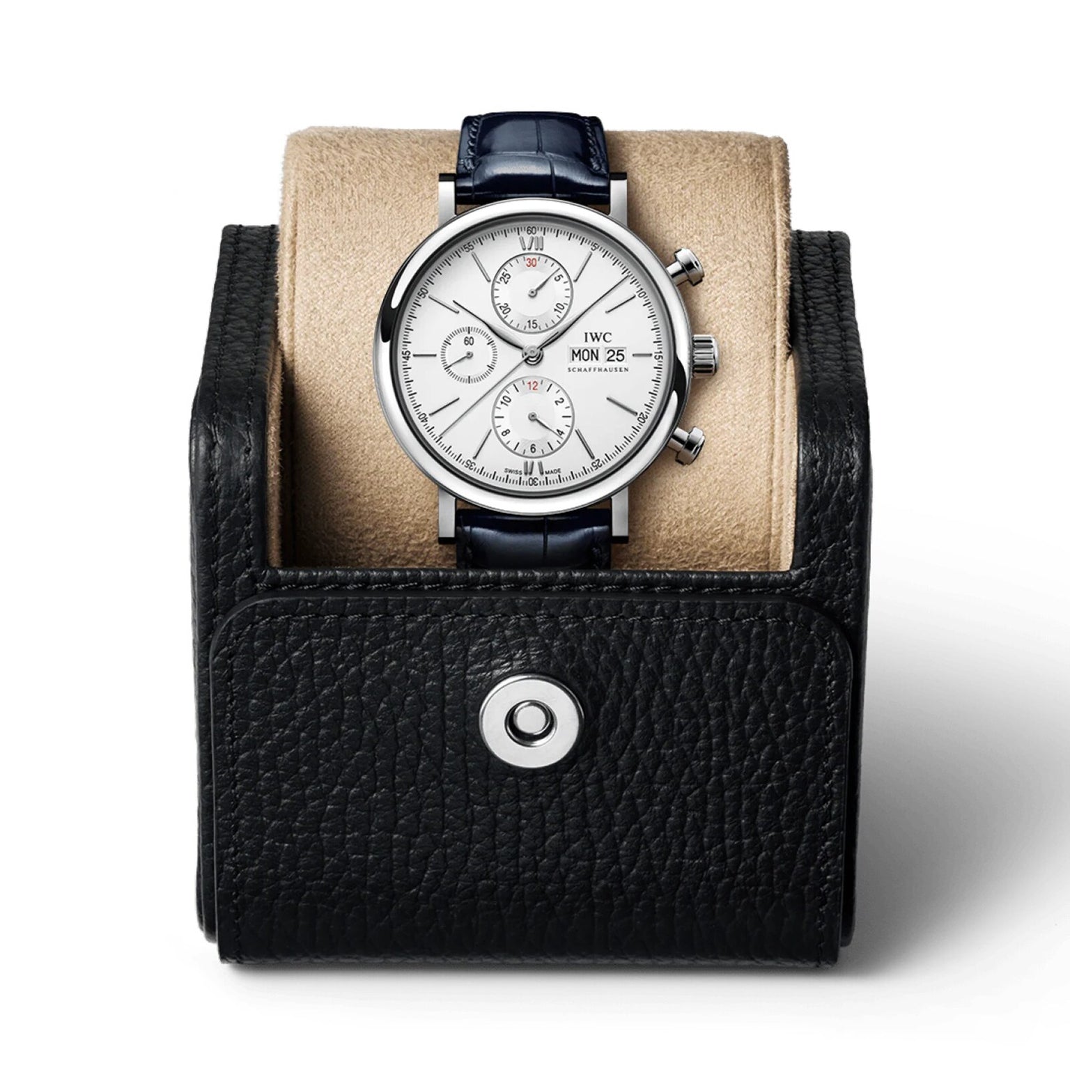The IWC Schaffhausen Portofino Chronograph, featuring a white dial, stainless steel case, and black leather strap, is displayed on a beige cushion inside a black leather watch case.