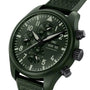 The IWC Schaffhausen Pilot’s Watch Chronograph TOP GUN Edition “Woodland” features a green dial with three subdials, white accents, fabric strap, and displays Monday the 25th.