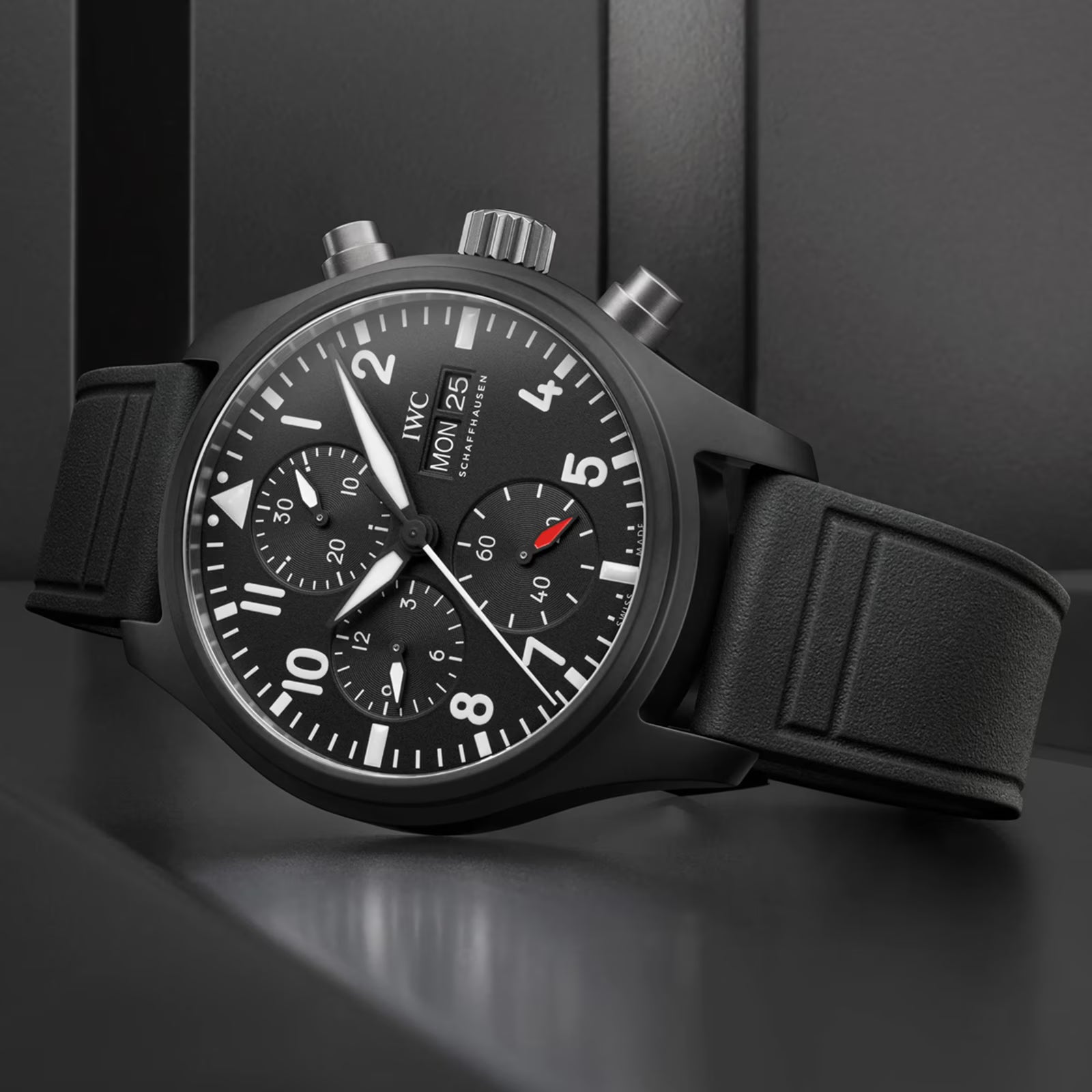 Black wristwatch with detailed face on a dark background