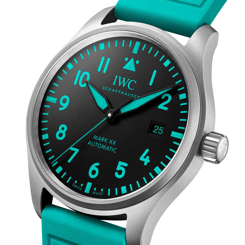 A close-up of the IWC Schaffhausen Pilots Watch Mark XX Mercedes-AMG PETRONAS, featuring a black dial with turquoise numerals, hands, and strap.