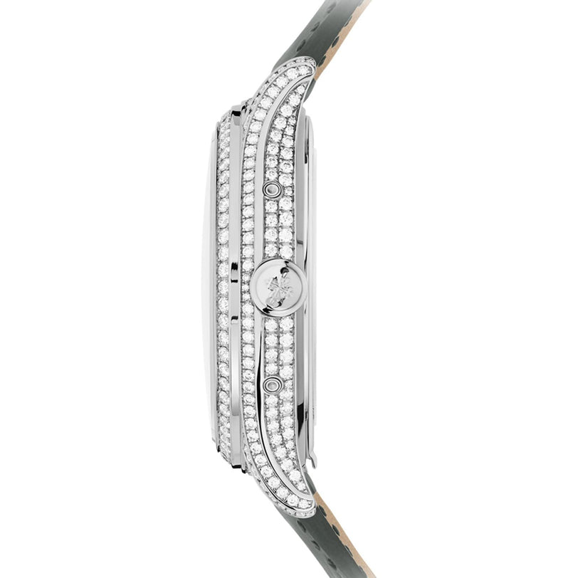 Side view of the Patek Philippe Complication 4948G-010, a slim silver watch featuring two diamond rows on the bezel and a patterned leather strap.