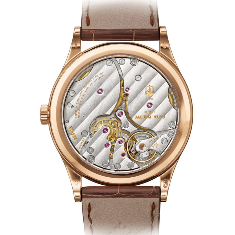 Back view of the Patek Philippe Calatrava 6119R-001 displaying its intricate mechanical movement, gold details, and a brown leather strap.