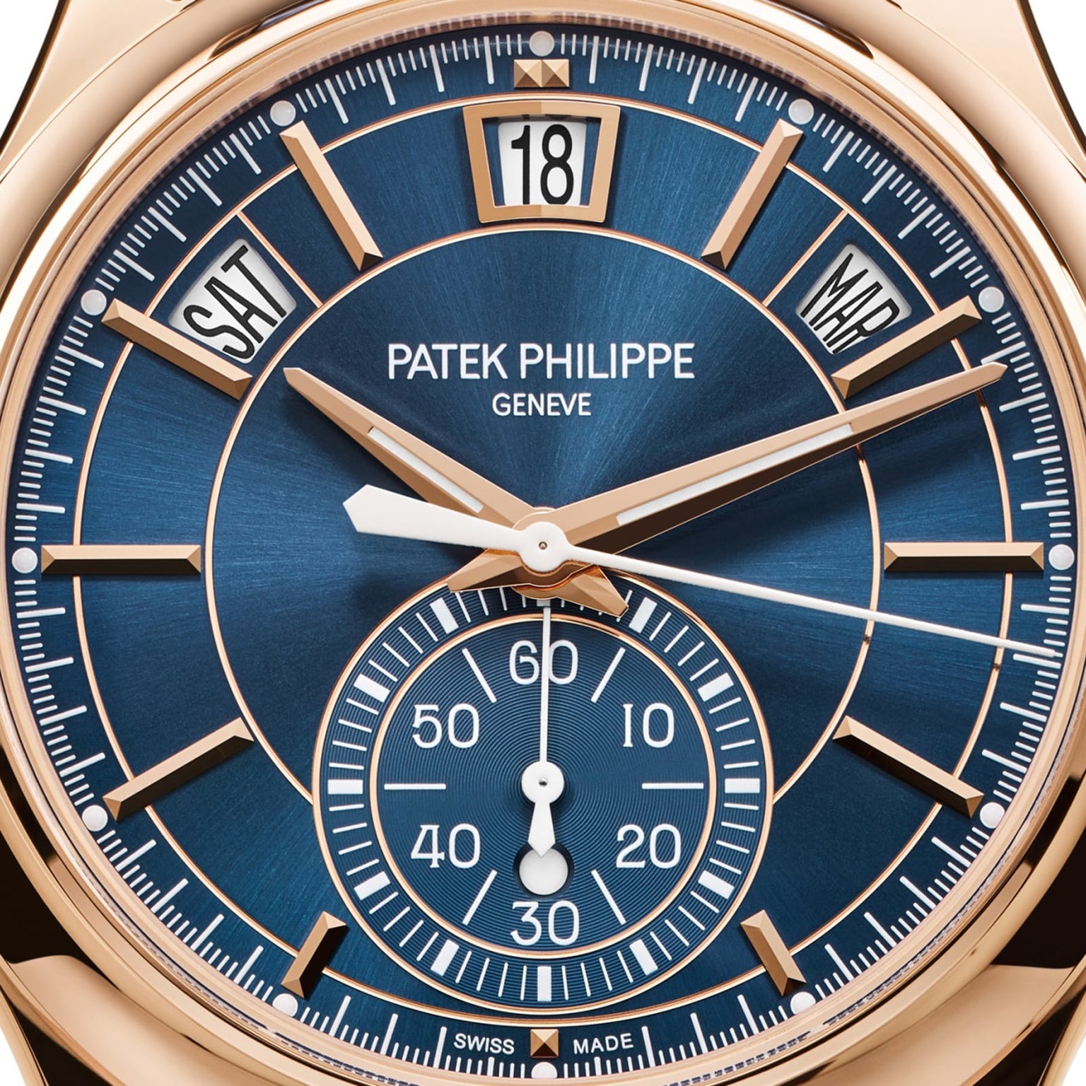 Close-up of the Patek Philippe Complications 5905R-010 watch, featuring a blue dial with displays for day, date, month, and seconds.