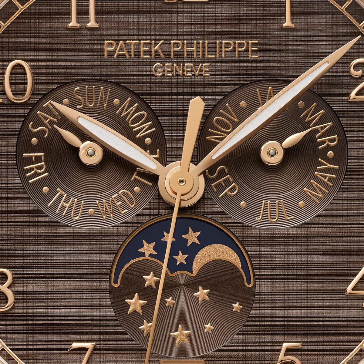 Close-up of the Patek Philippe Complications 4946R-001 watch face displaying day, month, and moonphase in gold and brown tones.