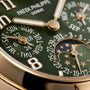 Close-up of the Patek Philippe Twenty~4 7340/1R-010 watch face in green, displaying days, dates, and moon phase details.