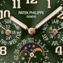 Close-up of a green Patek Philippe Twenty~4 7340/1R-010 watch face with gold hands, numerals, calendar, and moon phase display.