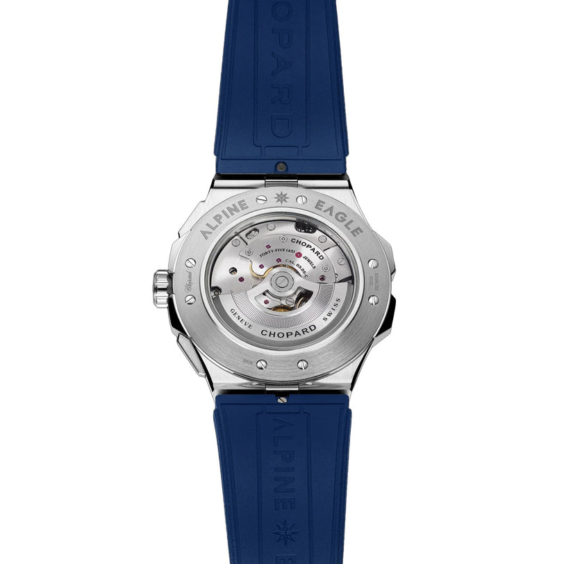Back view of the Chopard Alpine Eagle XL Chrono highlights Swiss craftsmanship with a visible automatic movement, silver case, and blue rubber strap embossed with Chopard.