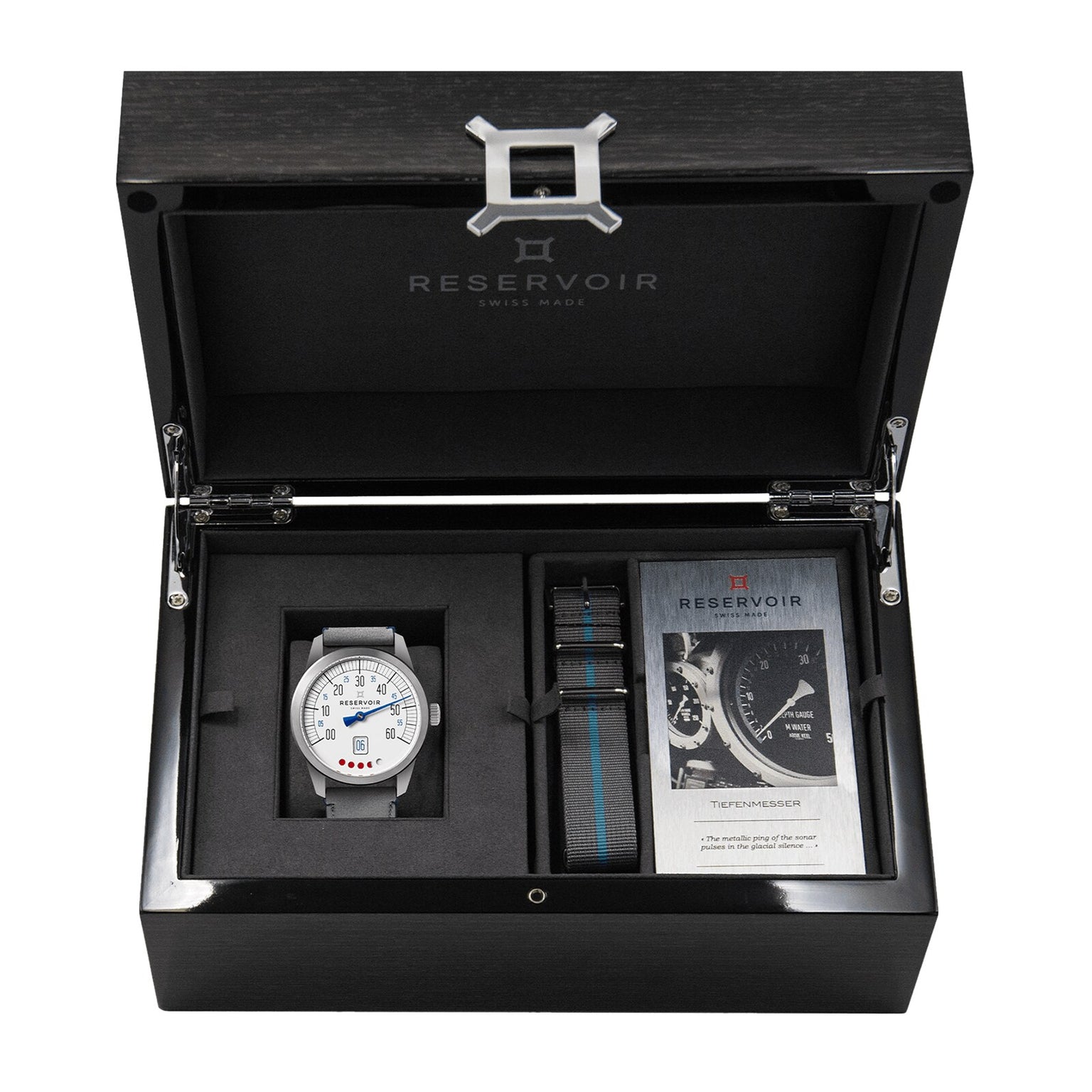 The Reservoir Tiefenmesser wristwatch, inspired by submarine equipment, comes in a sleek black box with an extra striped strap and instruction booklet—an ideal addition to any collection.