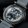 Close-up of the Speake Marin Openworked Tourbillon Black DLC’s transparent case back showcasing its intricate gears and mechanical movement.