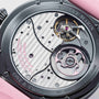Close-up of the Speake Marin Dual Time Pink watch movement, showcasing its intricate gears, screws, and detailed metal engravings.