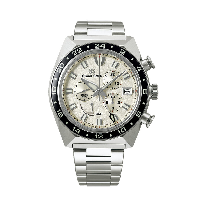 The Grand Seiko Spring Drive Chronograph Sport features a stainless steel case, silver dial, black bezel, Caliber 9R86 movement, chronograph subdials, date window at 3 o’clock, and a metal bracelet.