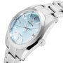 The Grand Seiko Automatic Heritage is a stainless steel watch with a light blue dial, silver hour markers, date window at 3 o’clock, and a matching metal bracelet.