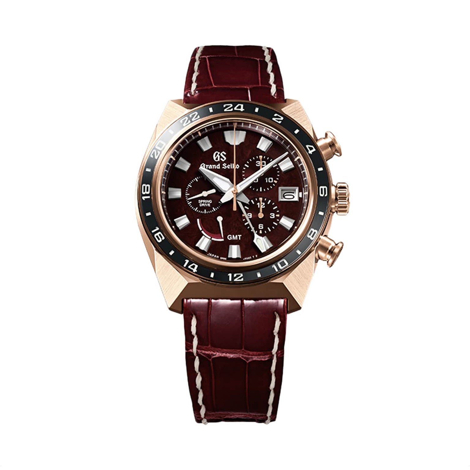 The Grand Seiko Spring Drive Sport features a brown leather strap, gold case, black and gold bezel, and a dark dial with chronograph subdials and date window—a perfect fusion of refined watchmaking in a classic sports watch.