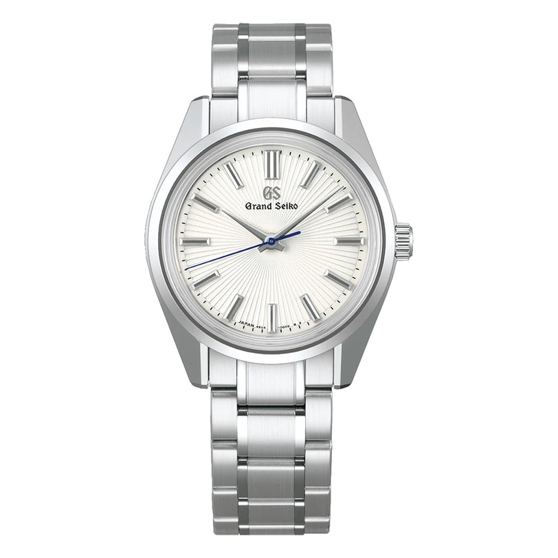 The Grand Seiko Manual Heritage features a stainless steel case, silver textured dial, silver hour markers, blue second hand, and a metal bracelet—showcasing the iconic 44GS Grand Seiko Style.