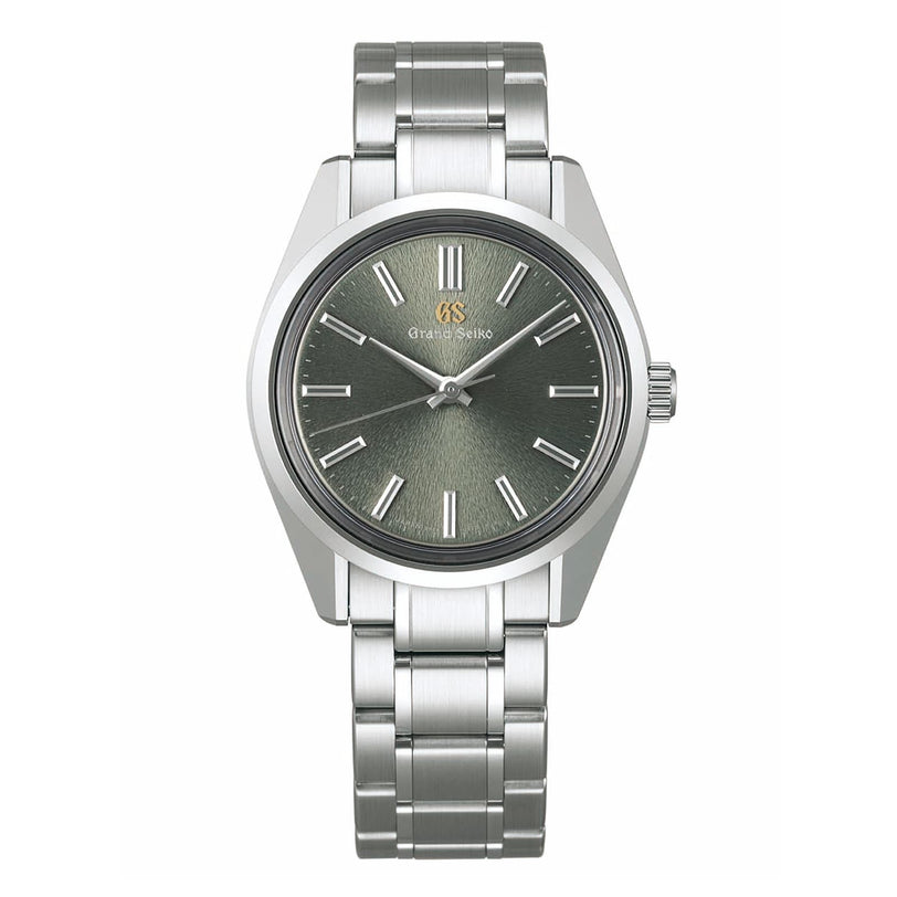 The Grand Seiko Manual Heritage wristwatch features a textured gray dial, silver hour markers, and a sleek metal bracelet, showcasing exquisite craftsmanship from the Heritage Collection.