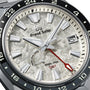 Close-up of the Grand Seiko Spring Drive GMT Sport watch face with a textured silver dial, bold hour markers, date window at 4 o’clock, red GMT hand, and Spring Drive and GMT printed on the dial.