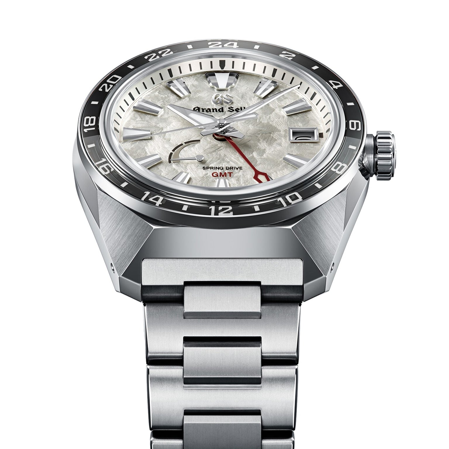 The Grand Seiko Spring Drive GMT Sport features a stainless steel band, textured white dial, black bezel, date window, red GMT hand, and is powered by the precise Spring Drive 9R66 Caliber.
