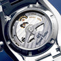 Close-up of the back of the Grand Seiko Spring Drive GMT Sport, showing its automatic movement, inscriptions, and visible mechanical components through a transparent case back.