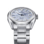 The Grand Seiko Hi-Beat 80 Hours Evolution 9 is a stainless steel wristwatch marking the 65th Anniversary, with a light blue mountainscape-textured dial, silver hour markers, date at 3 oclock, and metal bracelet on a white background.
