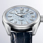 Grand Seiko Spring Drive U.F.A Evolution 9 wristwatch with a light blue textured dial and dark blue leather strap, shown in close-up.