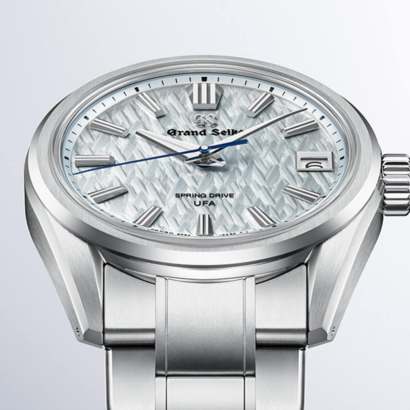 Grand Seiko Spring Drive U.F.A Evolution 9 wristwatch featuring a textured dial, blue second hand, and metal bracelet.