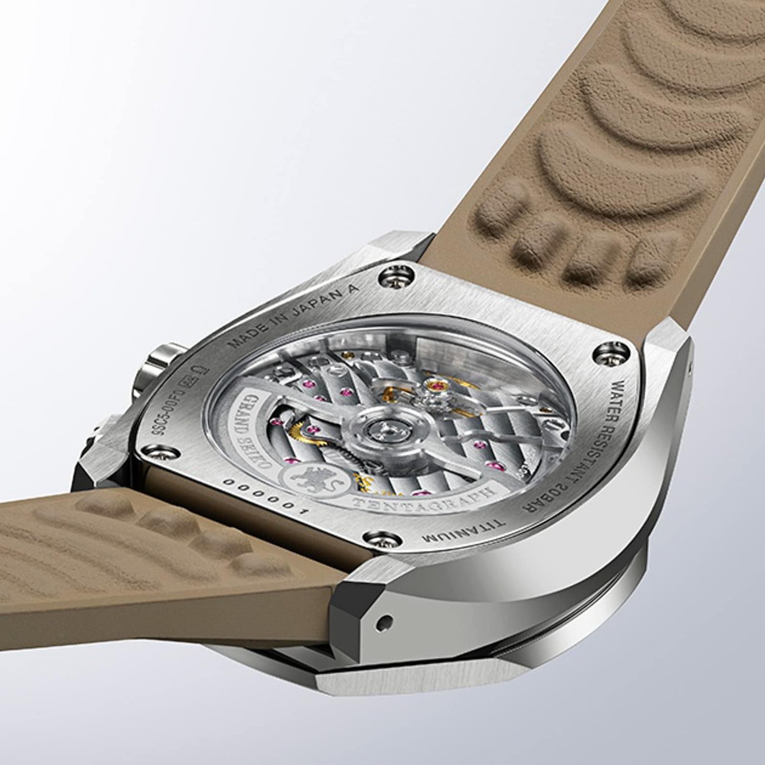 Close-up of the back of the Grand Seiko Hi-Beat 36000 Automatic Chronograph SLGC007 Evolution 9, showcasing its transparent case revealing the detailed mechanical movement, titanium case, and beige textured strap.