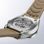 Close-up of the back of the Grand Seiko Hi-Beat 36000 Automatic Chronograph SLGC007 Evolution 9, showcasing its transparent case revealing the detailed mechanical movement, titanium case, and beige textured strap.