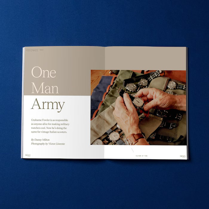 An open HODINKEE Magazine, Volume 9 by Hodinkee, displays One Man Army, showcasing hands arranging wristwatches on a fabric mat—a vivid tribute to horology and the art of timekeeping.