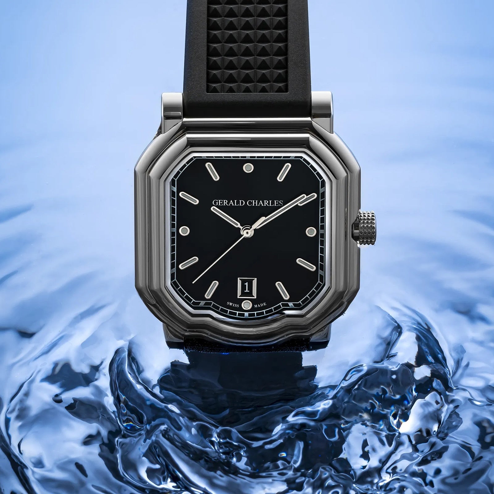 The Gerald Charles Maestro 2.0 Ultra-Thin watch, featuring a black strap and dial, is elegantly displayed against a rippling blue water background.