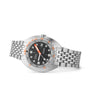 The DOXA Sub 300T Sharkhunter is a stainless steel diver’s watch with a black dial, silver bracelet, orange accents, Super-LumiNova details, and a date display at 3 o’clock, shown against a white background.