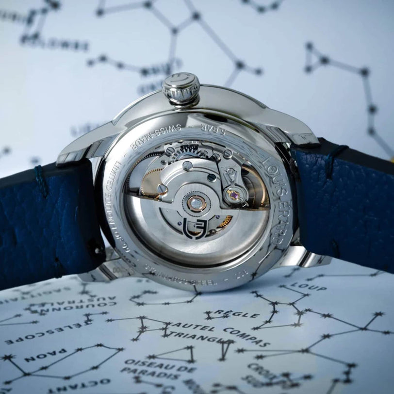 Close-up of the Louis Erard Petite Seconde Malachites transparent back, revealing its inner mechanism and paired with a blue leather strap.