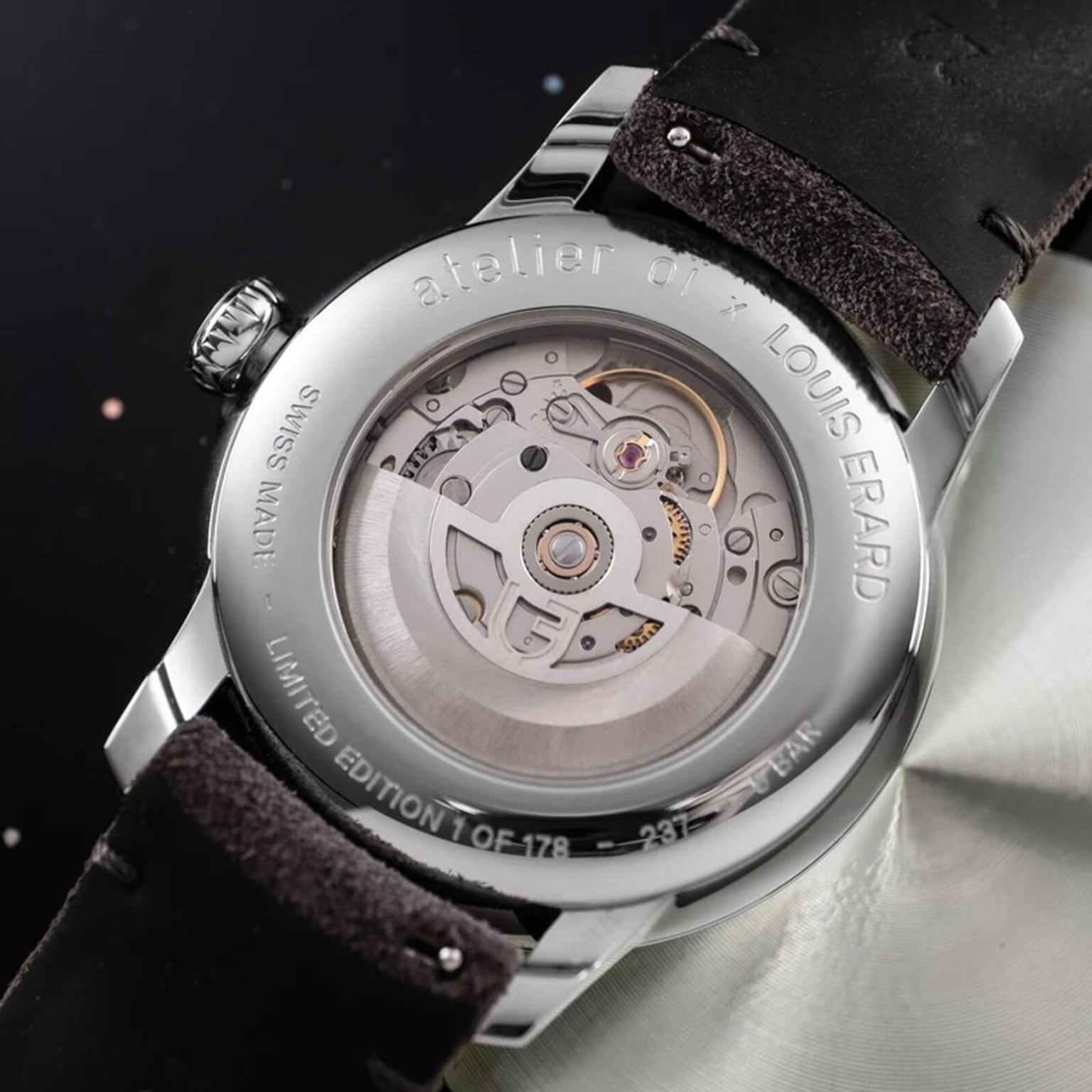 Close-up of the Le Régulateur Louis Erard x atelier oï by Louis Erard, highlighting its transparent case back with intricate mechanical movement and detailed engravings.