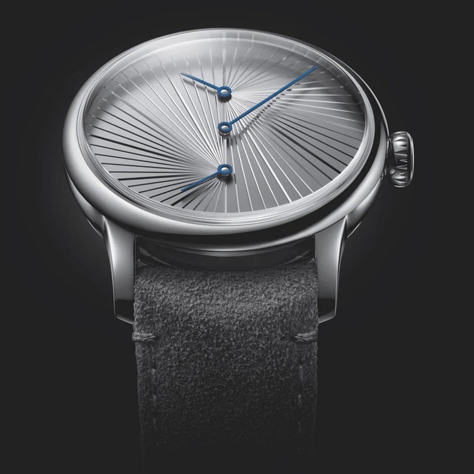 The Louis Erard Le Régulateur, created with atelier oï, features a silver dial with a radiating texture, blue hands, and a black leather strap, showcased against a dark backdrop.