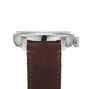 Side view of the Le Régulateur Louis Erard x seconde/seconde/ silver case watch by Louis Erard, featuring a brown suede strap with visible stitching, set against a white background.