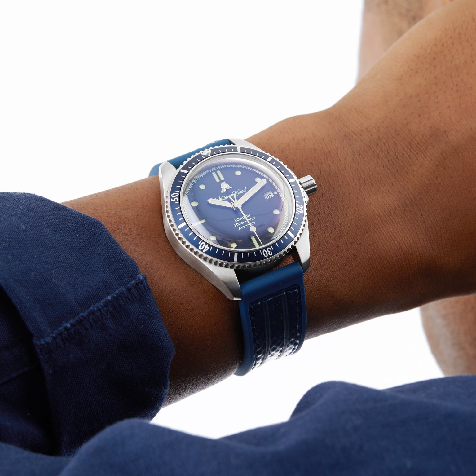 The William Wood Valiant Collection - The Blue Watch, featuring a blue dial and strap, shown on a wrist paired with a long-sleeve blue shirt.