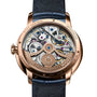 Close-up of the back of the Arnold & Son DSTB 42 Red Gold watch, featuring its exposed and intricate mechanical movement.