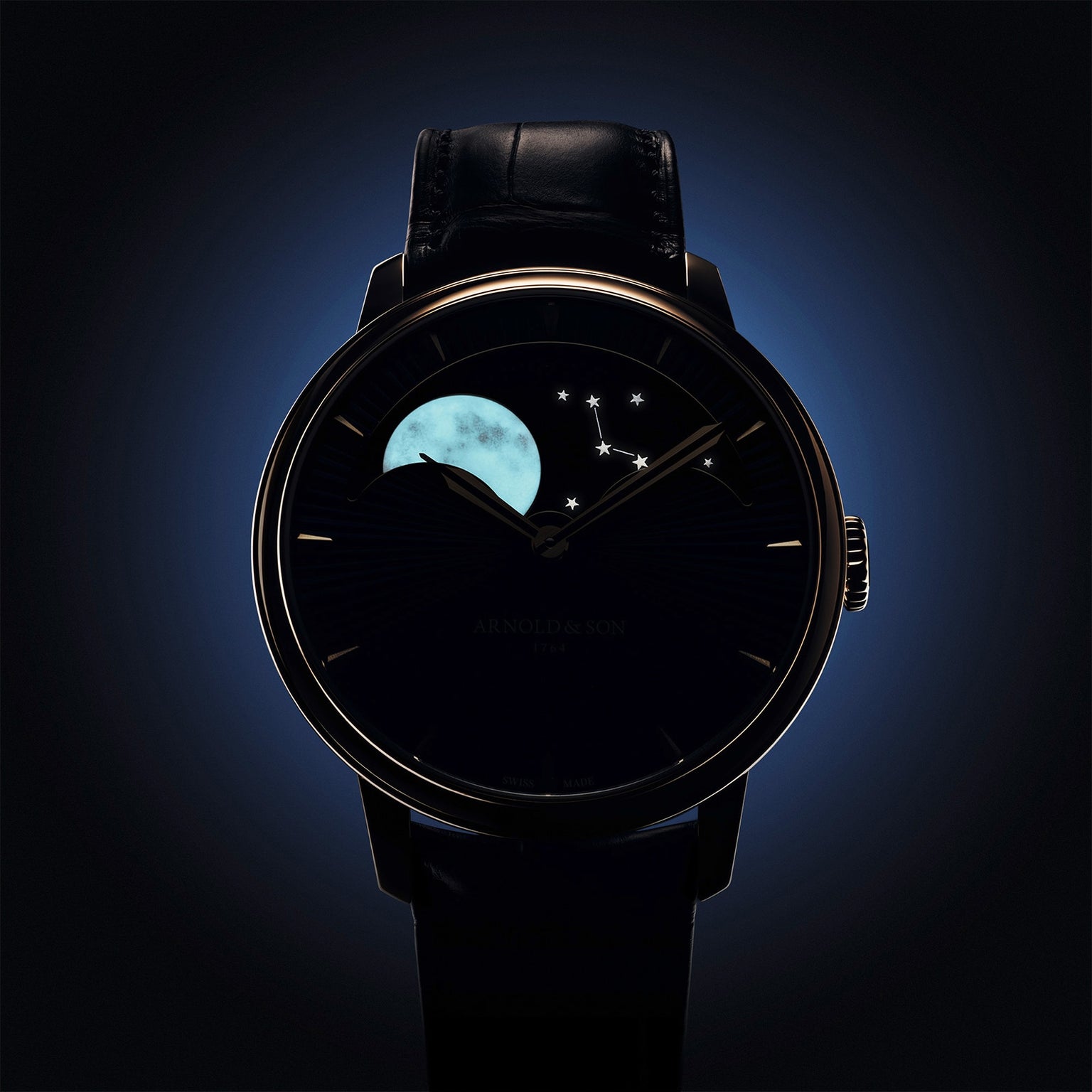 The Arnold & Son Perpetual Moon 41.5mm Red Gold is a luxury wristwatch featuring a moon phase and constellation display on its dark, illuminated dial.