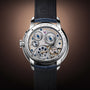 Close-up of the Arnold & Son Perpetual Moon 41.5mm Platinum showcasing its exposed mechanical movement, intricate gears, and elegant leather strap.