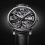 The Arnold & Son Nebula 38 Steel is a luxury skeleton watch with exposed gears and a black leather strap, set against a dark background.
