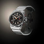 The Angelus Chronodate Titanium Black Titanium luxury wristwatch features a black dial and titanium strap, elegantly displayed against a gradient dark background.