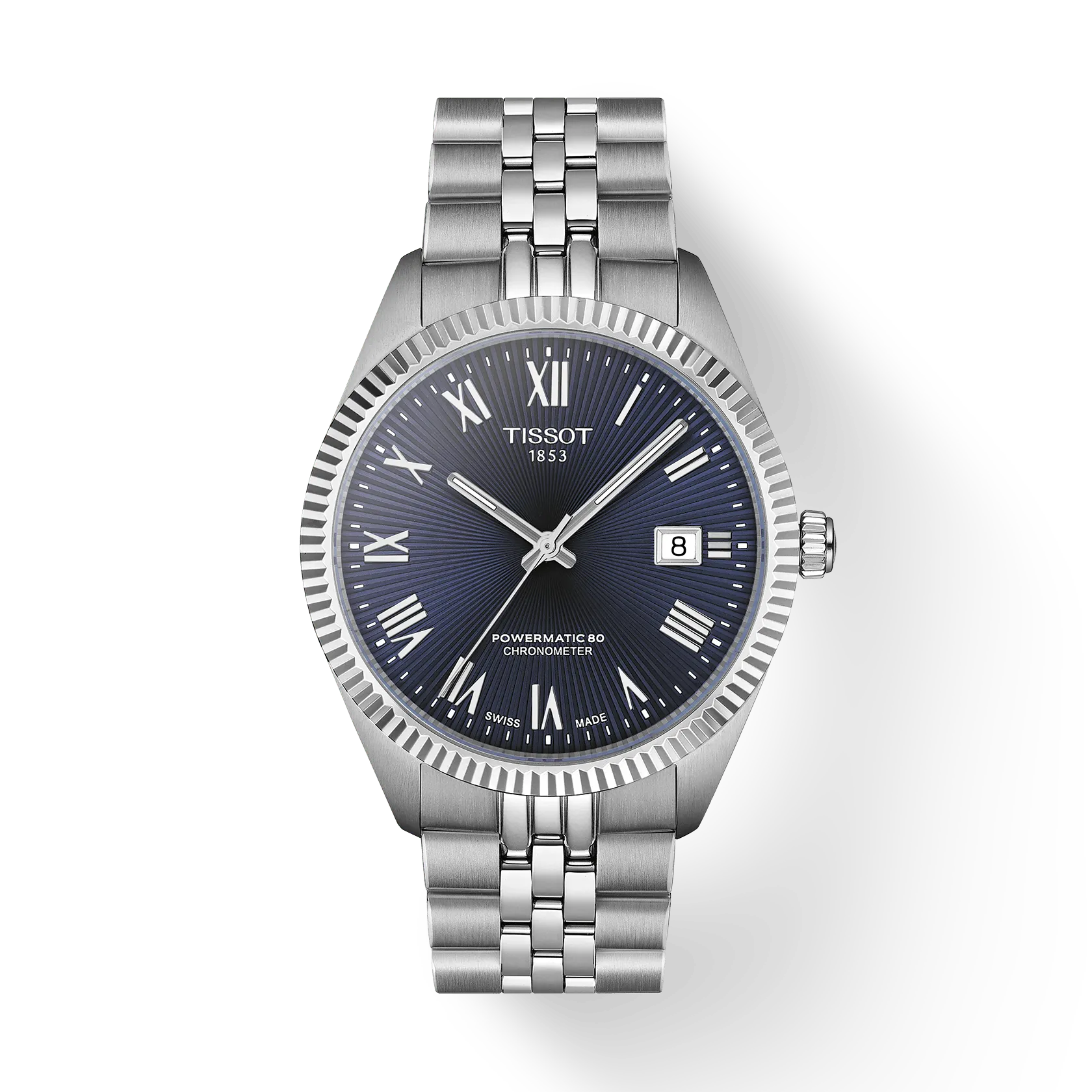 The Tissot Ballade 39 is a stainless steel wristwatch with a blue textured dial, silver Roman numerals, date window at 3 o’clock, and silver link bracelet, featuring chronometer-certified COSC precision, shown on a white background.