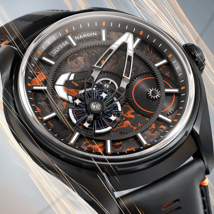 Luxury watch with intricate design and visible brand name on a blurred background
