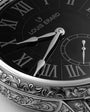 Close-up of a Louis Erard watch face with detailed engraving.